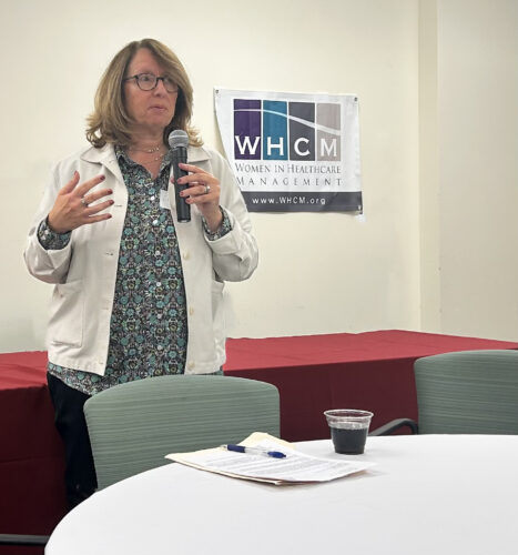 woman with a microphone speaking