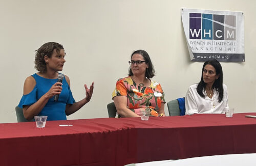 women speaking at a table